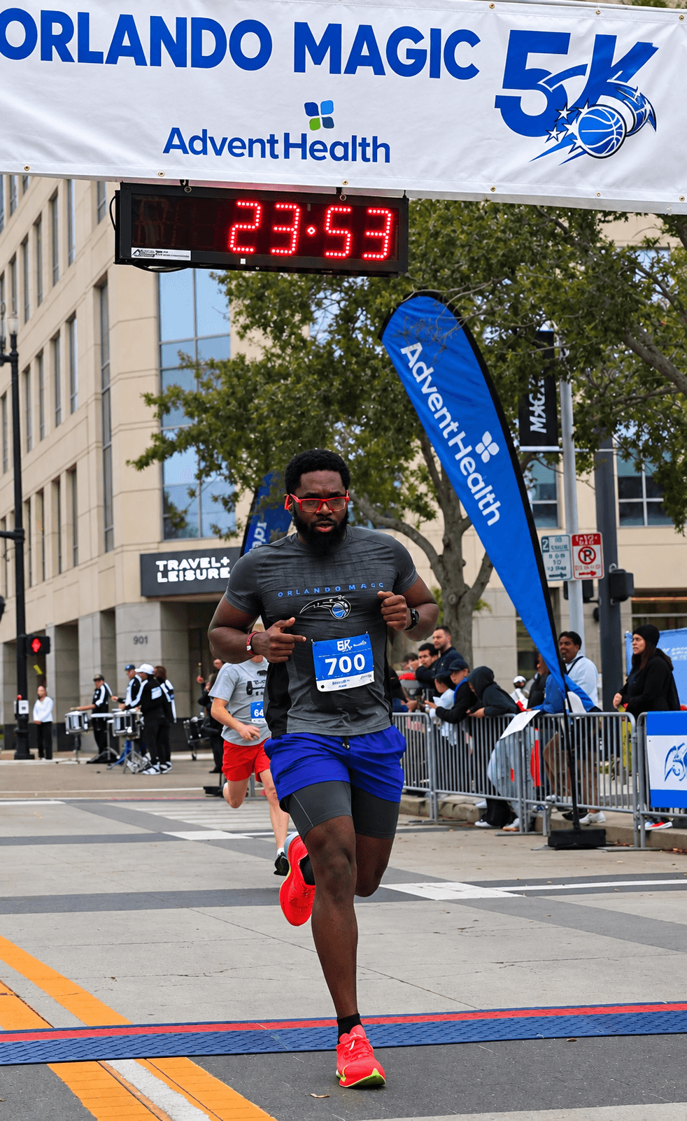 John Castor crossing the finish line at the Orlando Magic 5K